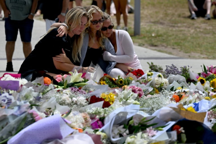 Des personnes se rassemblent le 15 décembre 2025 devant le Bondi Pavillion, en mémoire des victimes de la fusillade de la plage de Bondi, à Sydney ( AFP / Saeed KHAN )