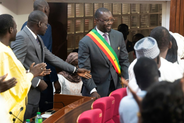 L'ancien Premier ministre sénégalais Ousmane Sonko (c), élu président de l'Assemblée nationale, porte son écharpe parlementaire à Dakar, le 26 mai 2026 ( AFP / SEYLLOU )