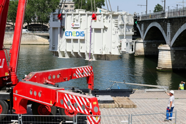 Arrivée du transformateur Enedis, un cube de 130 tonnes, au port de Tolbiac à Paris le 22 juin 2026. ( AFP / Mehdi FEDOUACH )