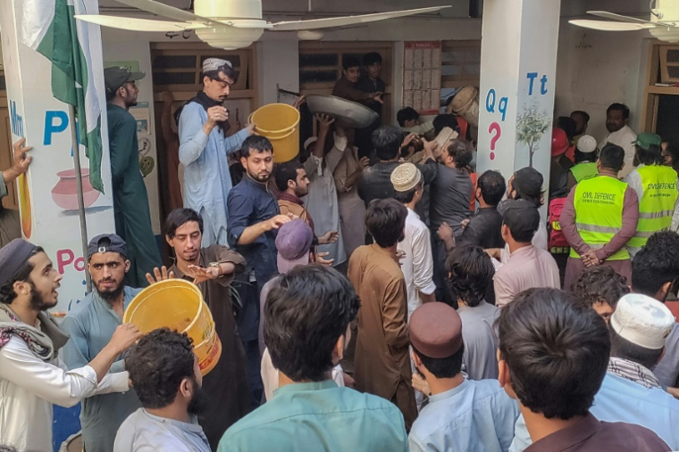 Des secouristes et des habitants mènent une opération de recherche après l’effondrement du toit d’une école à Peshawar, le 15 octobre 2026 ( AFP / Abdul MAJEED )