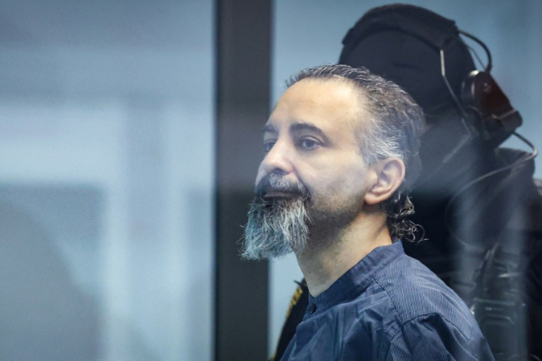 L'accusé saoudien Taleb Jawad al-Abdulmohsen (c) dans le box en verre pare-balle de la salle d'audience provisoire de Magdebourg, lors de son procès pour avoir foncé avec un SUV dans la foule d'un marché de Noël fin 2024, le 26 juin 2026 dans l'est de l'Allemagne ( AFP / Ronny HARTMANN )
