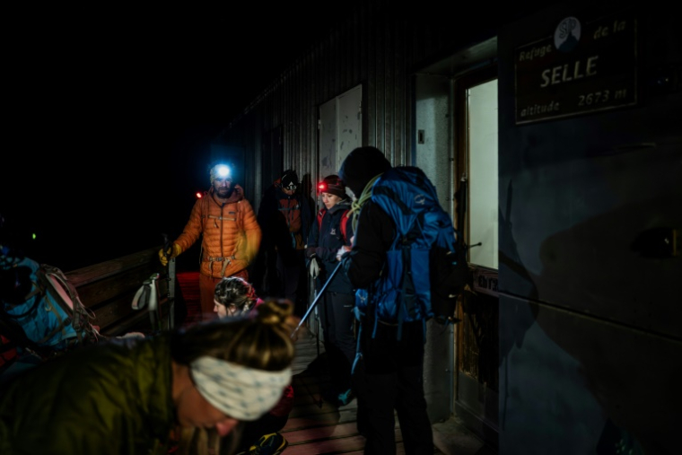 Des randonneurs partent du refuge à l'aube pour gravir le glacier de la Selle dans le massif des Ecrins, à Saint-Christophe-en-Oisans, en Isère, le 9 juillet 2025  ( AFP / JEFF PACHOUD )