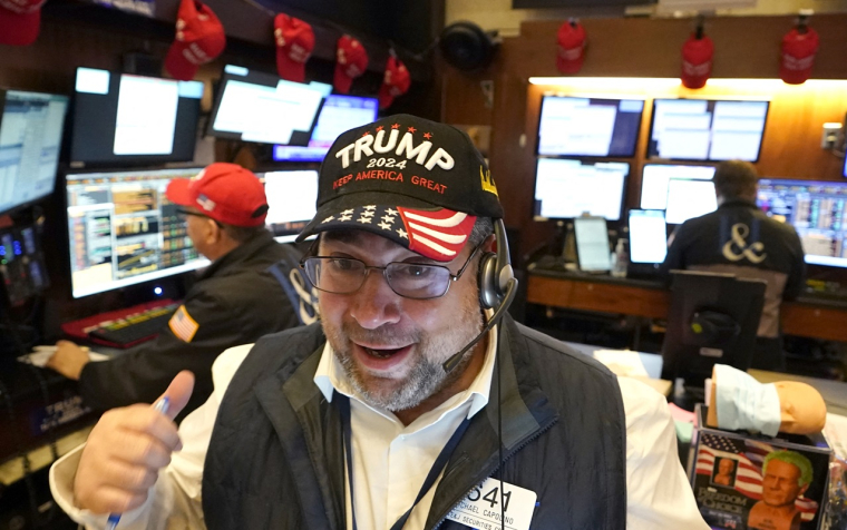 Un trader américain travaillant au Nyse avec une casquette Trump. (crédit : Thimothy A. Clark / AFP)