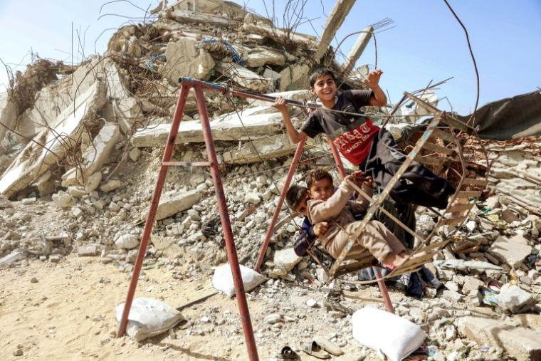Des enfants palestiniens jouent dans les décombres d'un immeuble détruit, le 16 février 2026 à Gaza-ville ( AFP / Omar AL-QATTAA )