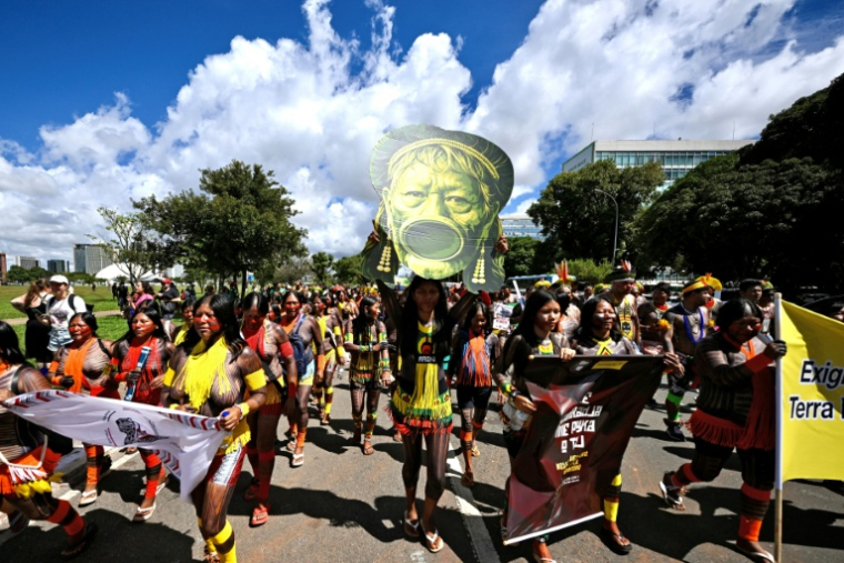 Indigenous people carry an image of leader Raoni Metuktire as they march to the Congress building during the annual Indigenous gathering Acampamento Terra Livre (ATL) in Brasilia on April 7, 2026. Around 7,000 indigenous people from several ethnic groups take part in the week-long protest to demand land rights, justice, and equal treatment. ( AFP / Evaristo Sa )