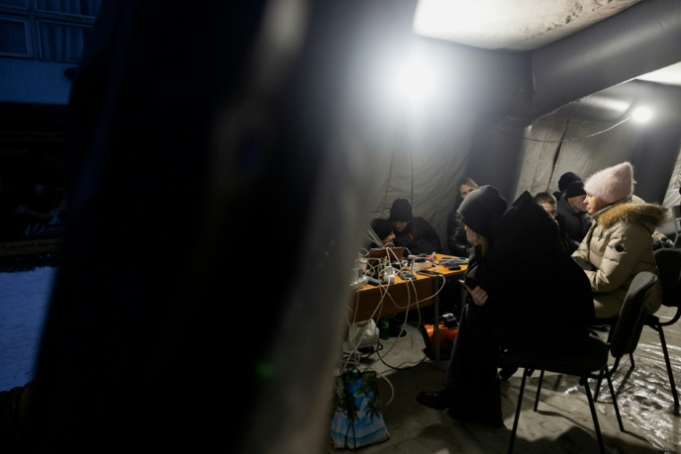 Des habitants dans l'obscurité à Vyshgorod, près de Kiev, le 30 décembre 2025 ( AFP / Tetiana DZHAFAROVA )