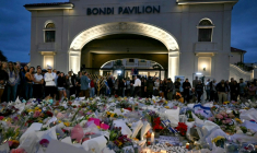 Des personnes se recueillent devant le Bondi Pavillion en hommage aux victimes d'un attentat à Bondi Beach, le 15 décembre 2025 à Sydney, en Australie ( AFP / Saeed KHAN )