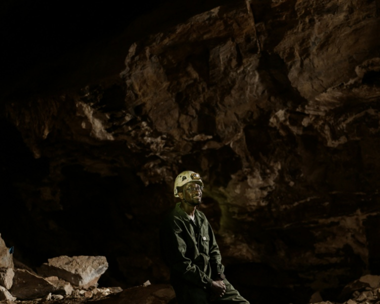Le géologue sud-africain Tebogo Makhubela dans la grotte de Rising Star en Afrique du Sud le 26 juin 2024 ( AFP / MARCO LONGARI )