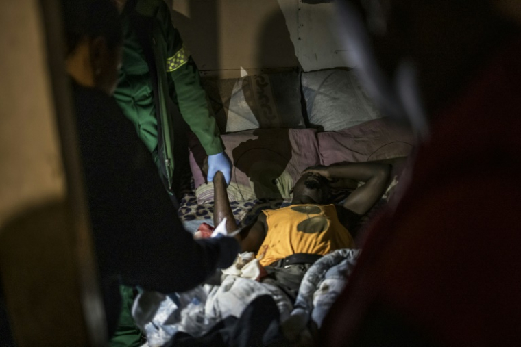 Un blessé est pris en charge par des ambulanciers lors d'une intervention au township Philippi, près du Cap, le 15 avril 2025 en Afrique du Sud ( AFP / MARCO LONGARI )
