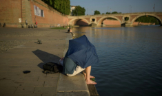 Un homme se protège du soleil, le 20 juin 2025 à Toulouse ( AFP / Ed JONES )