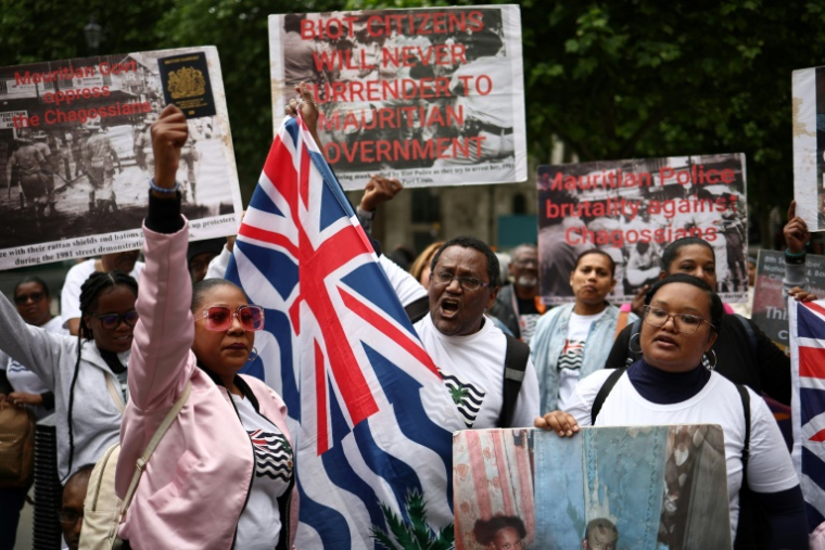Des membres de la communauté chagossienne rassemblés devant la Haute Cour de Londres, le 22 mai 2025, pour protester contre la signature de l'accord de restitution par le Royaume-Uni des îles Chagos à Maurice ( AFP / HENRY NICHOLLS )