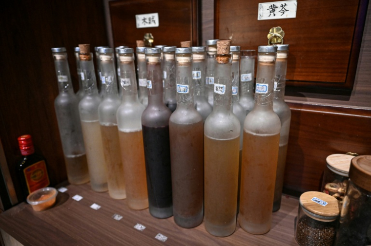 Des bouteilles de liqueurs médicinales à base de plantes, présentées sur la table d'un bar à cocktails à Shanghai,  le 11 février 2026 en Chine ( AFP / Jade GAO )