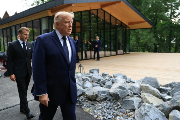 Le président américain Donald Trump (au centre) arrive aux côtés du président français Emmanuel Macron avant la prise d'une photo de groupe lors d'un dîner de gala organisé dans le cadre du G7, à Evian, en Haute-Savoie, le 16 juin 2026 ( POOL / Ludovic MARIN )
