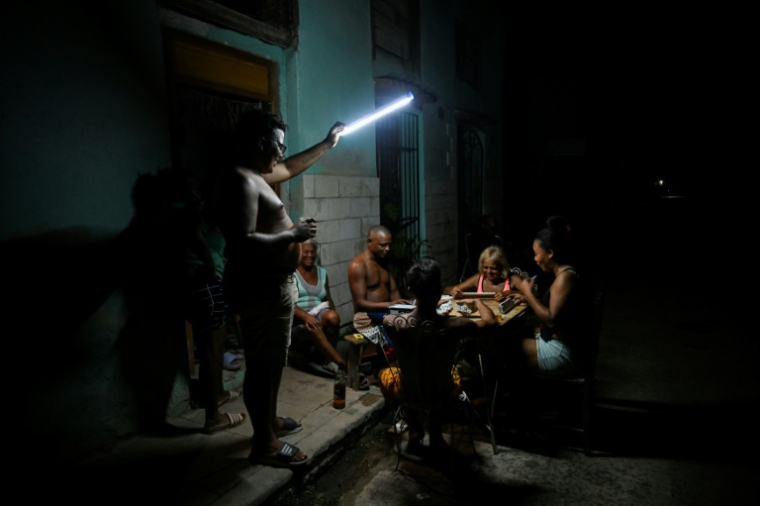 Des Cubains jouent au domino dans une rue de La Havane alors que l'île est plongée dans le noir en raison d'une nouvelle coupure générale d'électricité, la cinquième en moins d'un an, le 10 septembre 2025 ( AFP / YAMIL LAGE )