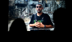Le photographe palestinien Mahmoud Abu Hamda prononce un discours préenregistré, diffusé sur écran, après avoir reçu le prix du jury international de l'édition 2026 du Prix Bayeux Calvados-Normandie des correspondants de guerre, à Bayeux, le 10 octobre 2026 ( AFP / Guillaume Saligot )