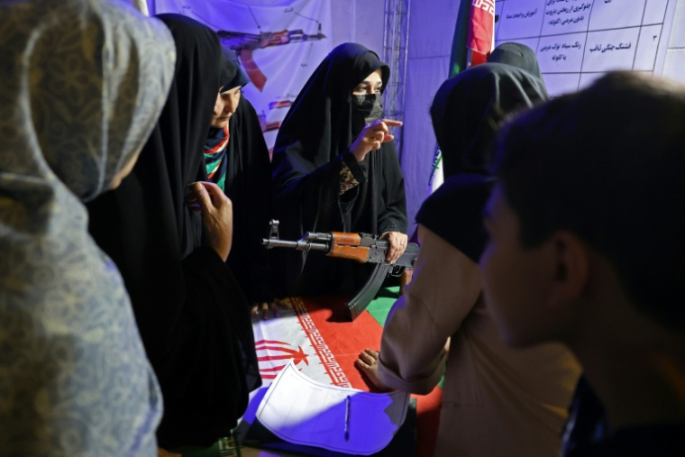 Des Iraniennes apprennent le maniement des armes dans un stand sur la place Hafter Tir de Téhéran, le 17 mai 2026 ( AFP / - )