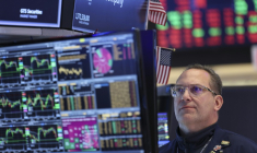 A trader works on the floor of the New York Stock Exchange (NYSE) at the opening bell in New York on March 24, 2026. European and US stocks resumed sliding and oil prices jumped on Tuesday as traders turned cautious over the prospect of a negotiated agreement between the United States and Iran to end the Middle East war. ( AFP / ANGELA WEISS )