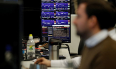 Des traders travaillent chez CMC Markets dans la City de Londres